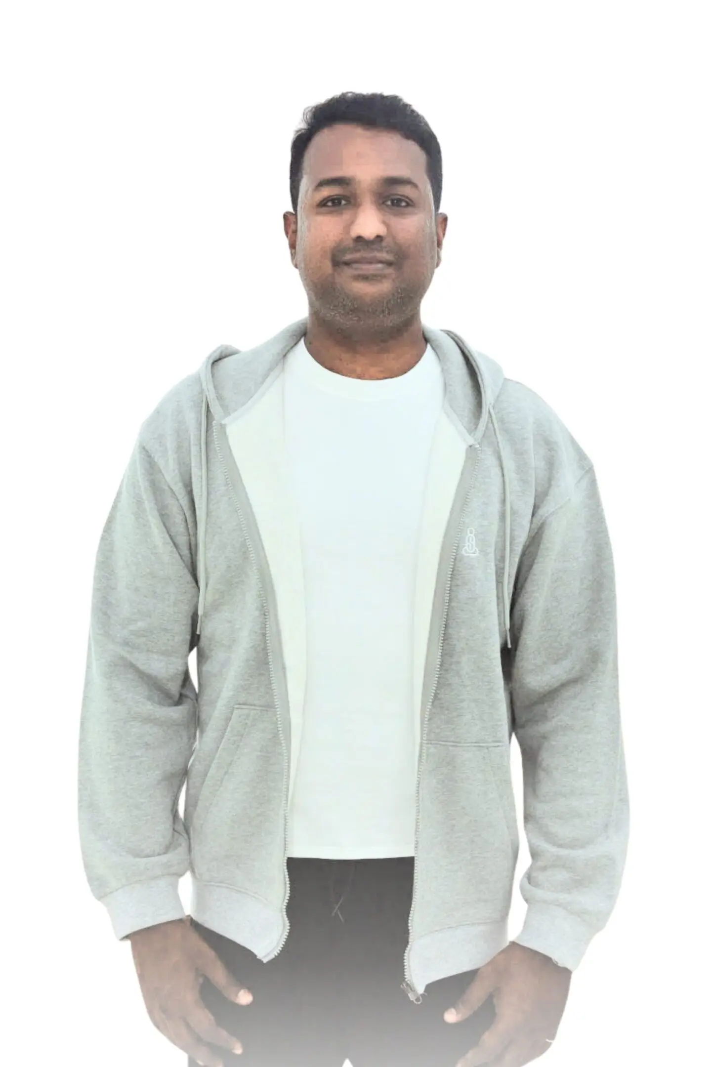 Man wearing a light gray hoodie over a white t-shirt, smiling.