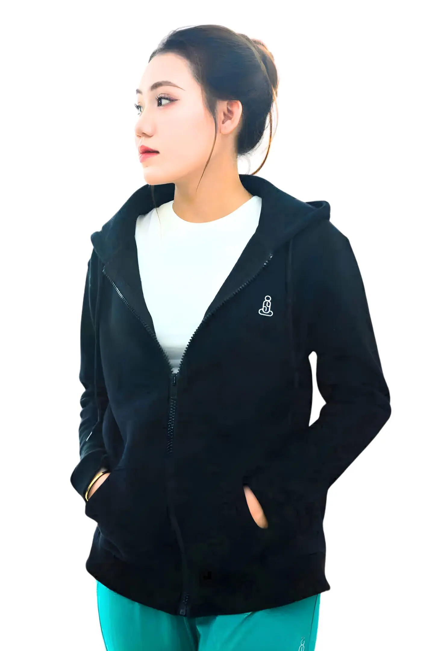 Woman wearing a black zip-up hoodie with hands in pockets.